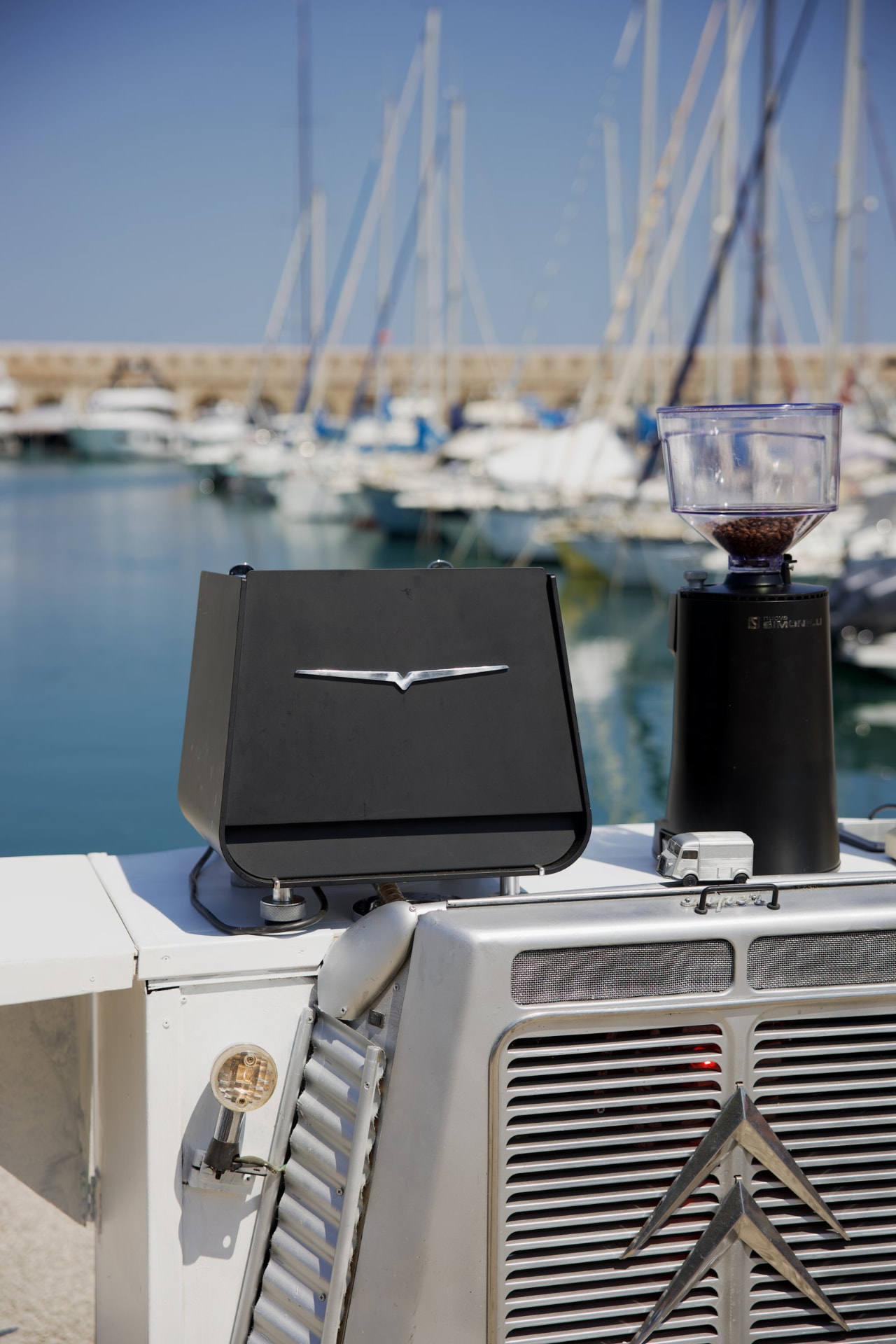 Specialty coffee espresso machine and grinder overlooking a French Riviera marina