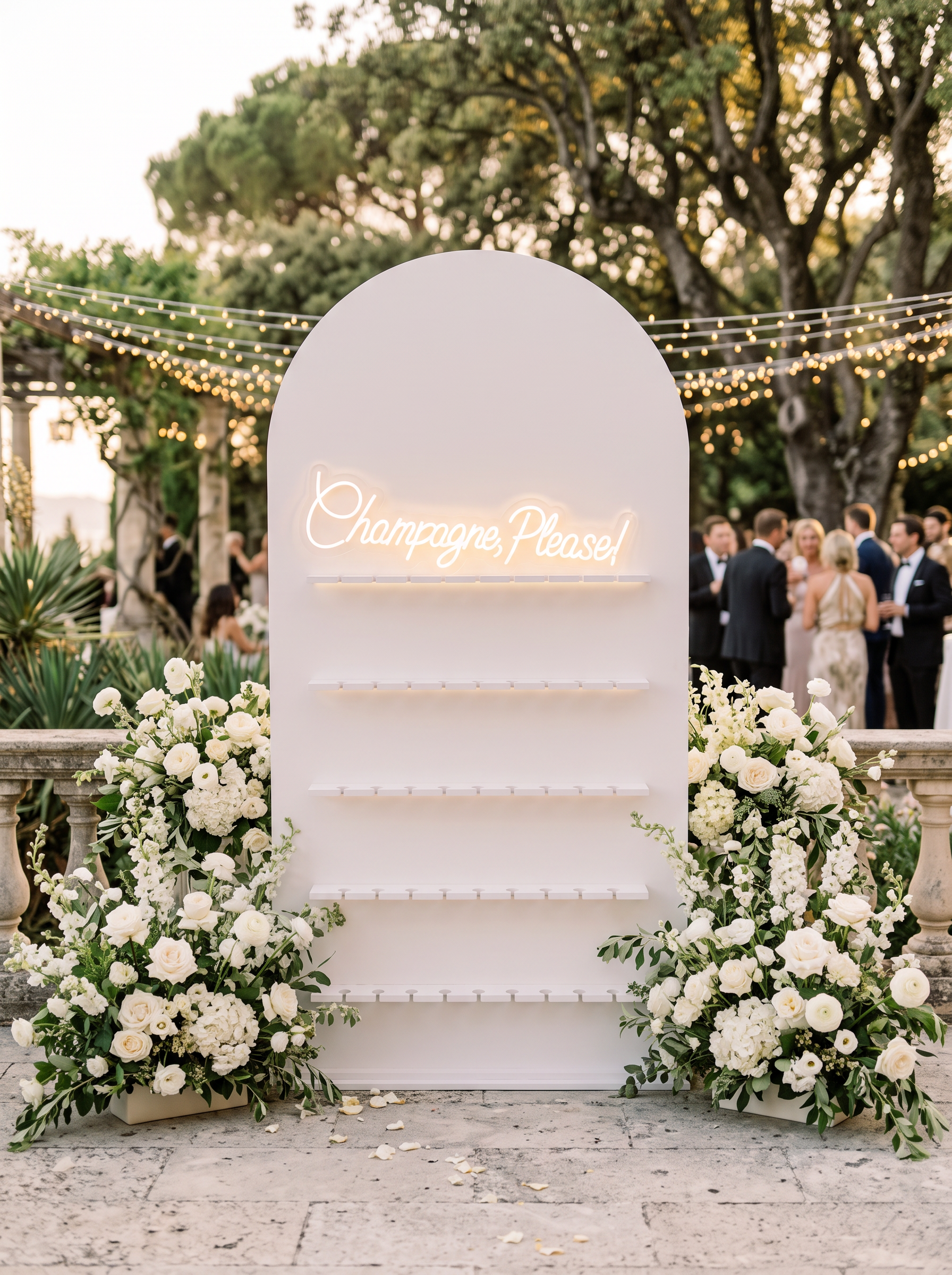 Riviera host carrying a tray of chilled champagne coupes among guests